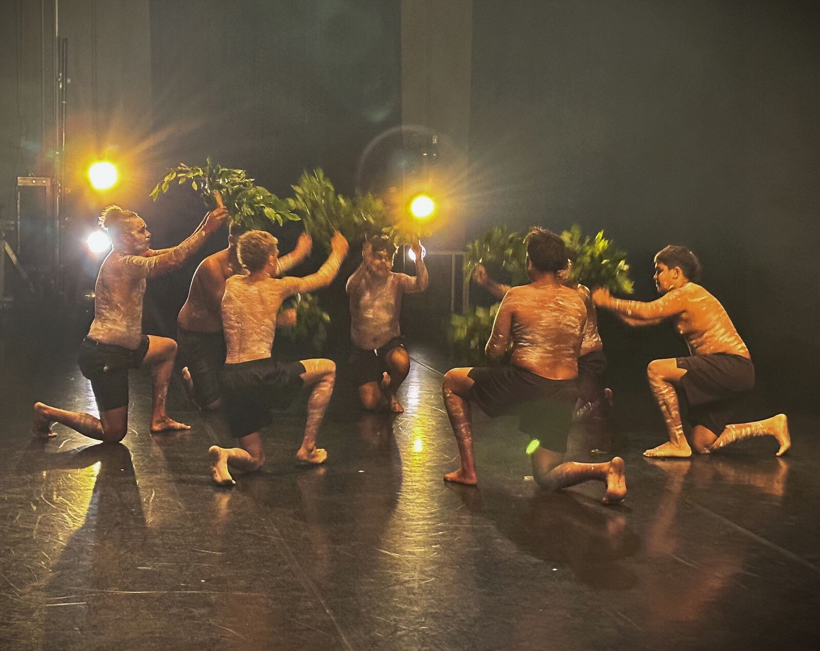 Dusty Feet Mob dancers sharing a moment with a young audience member