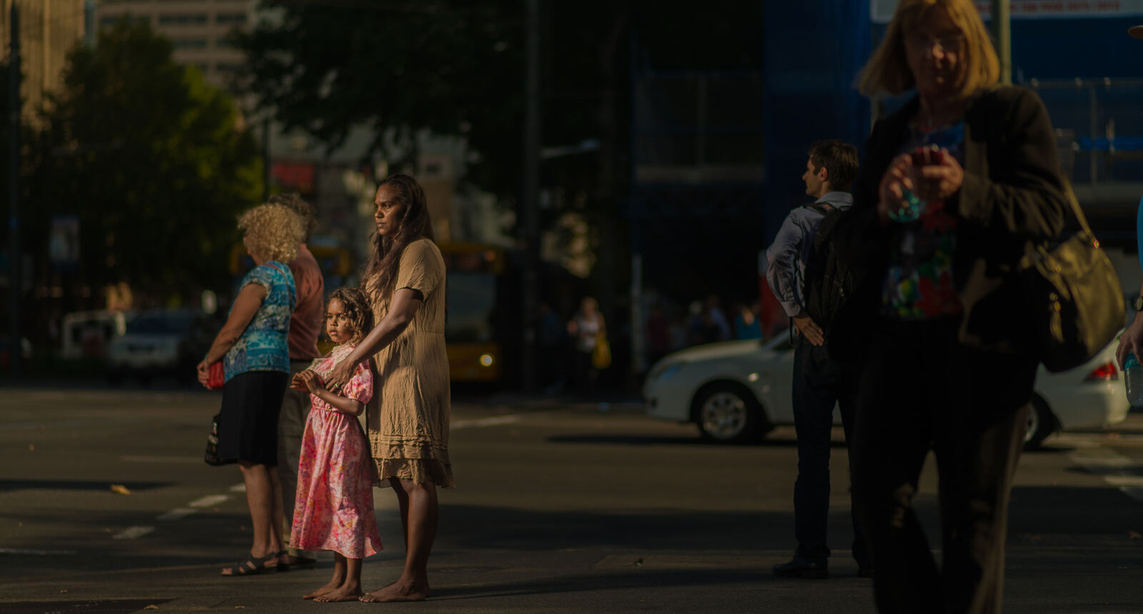 Mother and child standing barefoot on an Adelaide street